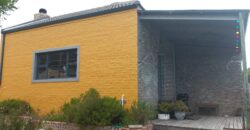 “The Little Yellow House with a Big Heart”
